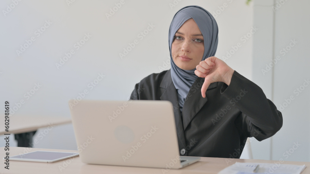 Thumbs Down by Arab Businesswoman Working on Laptop Thumbs Down by Arab Businesswoman Working on Laptop
