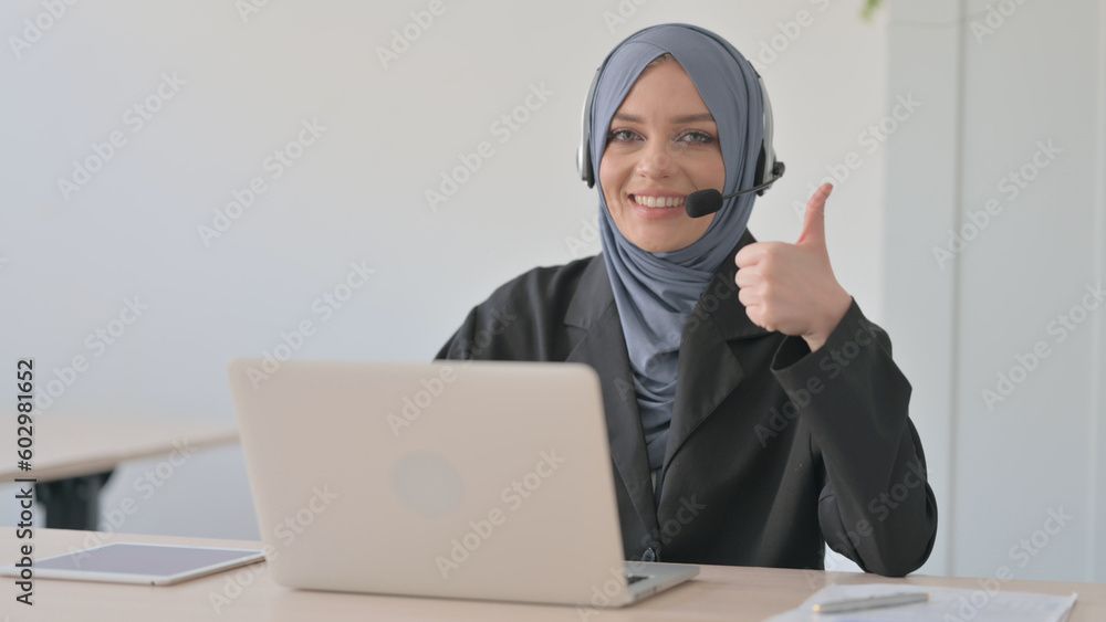 Thumbs Up by Arab Businesswoman with Headset in Call Centre Thumbs Up by Arab Businesswoman with Headset in Call Centre