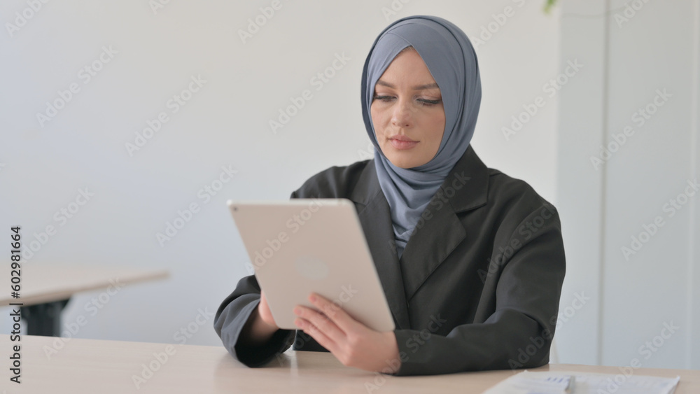 Cheerful Arab Businesswoman using Tablet PC