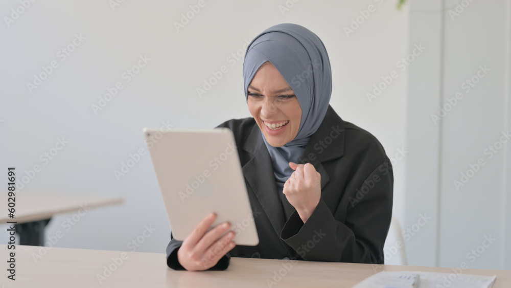 Arab Businesswoman Celebrating Success on Tablet PC Arab Businesswoman Celebrating Success on Tablet PC