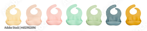 Baby bibs of different colors made of silicone on a white background