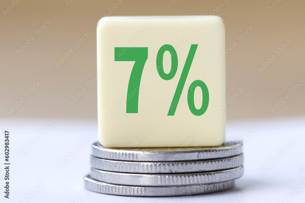 The concept of the word 7 percent on coins. Business concept.