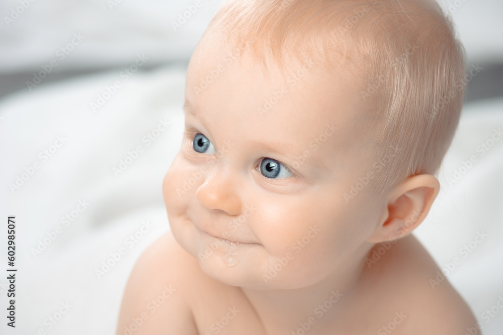 Cute baby with blue eyes - closeup portrait. Little boy looking away. Cute baby with blue eyes - closeup portrait. Little boy looking away.