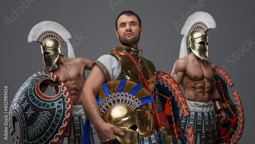 Portrait of ancient warlord fromt greece and two greek warriors with shields.