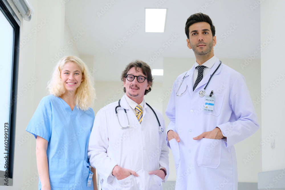 Smiling medical team standing inside the hospital. Smiling medical team standing inside the hospital.