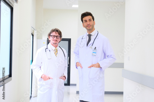 Smiling male doctor standing in the hospital.