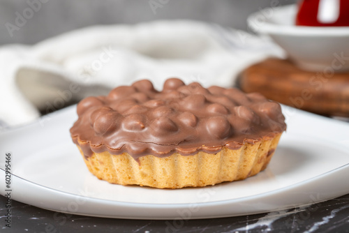Chocolate pie. Hazelnut, cream and chocolate pie on dark background. Close up