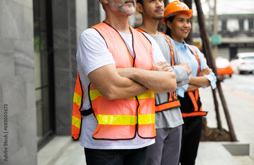 Unity and teamwork concept. Architect contractor senior man and team engineering standing together in construction site. Professional construction civil engineer team Unity and teamwork concept. Architect contractor senior man and team engineering standing together in construction site. Professional construction civil engineer team