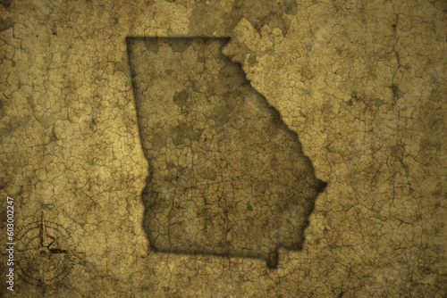 map of georgia state on a old vintage crack paper background .