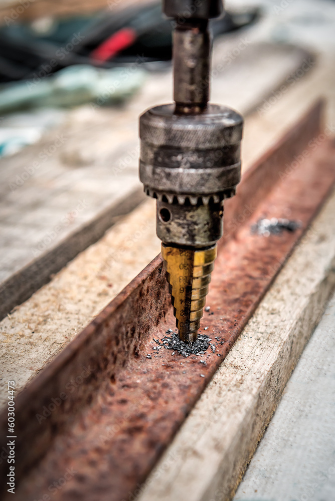 Metal drill bit make holes in rusty steel. Metal work industry Metal drill bit make holes in rusty steel. Metal work industry