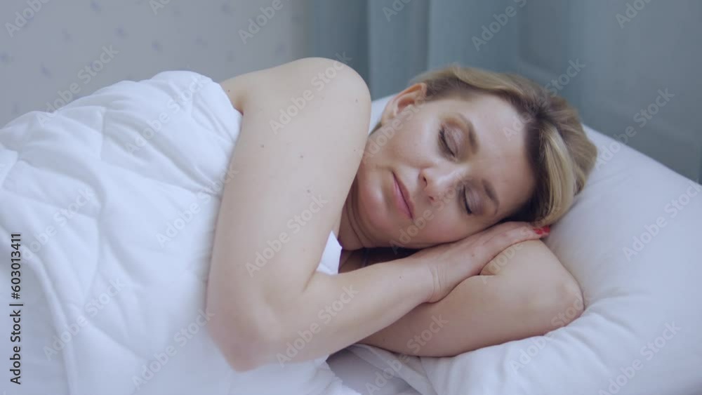 Happy sleepy woman slowly waking up early in the morning in a great mood, cheerful and healthy, perfect sleep conditions, top-view Happy sleepy woman slowly waking up early in the morning in a great mood, cheerful and healthy, perfect sleep conditions, top-view