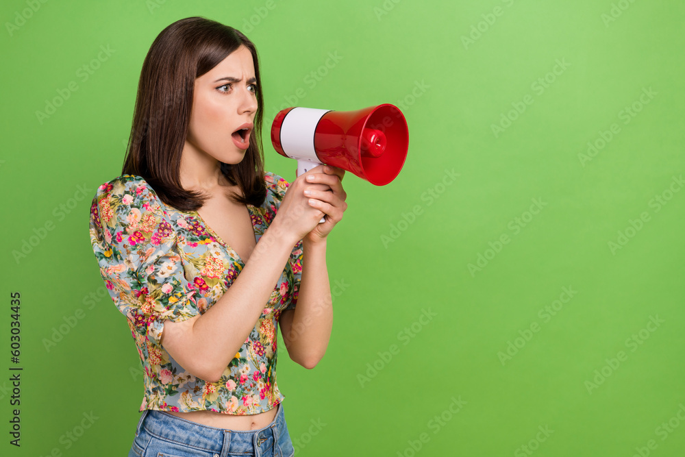 Profile photo of unsatisfied person hands hold loudspeaker communicate empty space isolated on green color background Profile photo of unsatisfied person hands hold loudspeaker communicate empty space isolated on green color background
