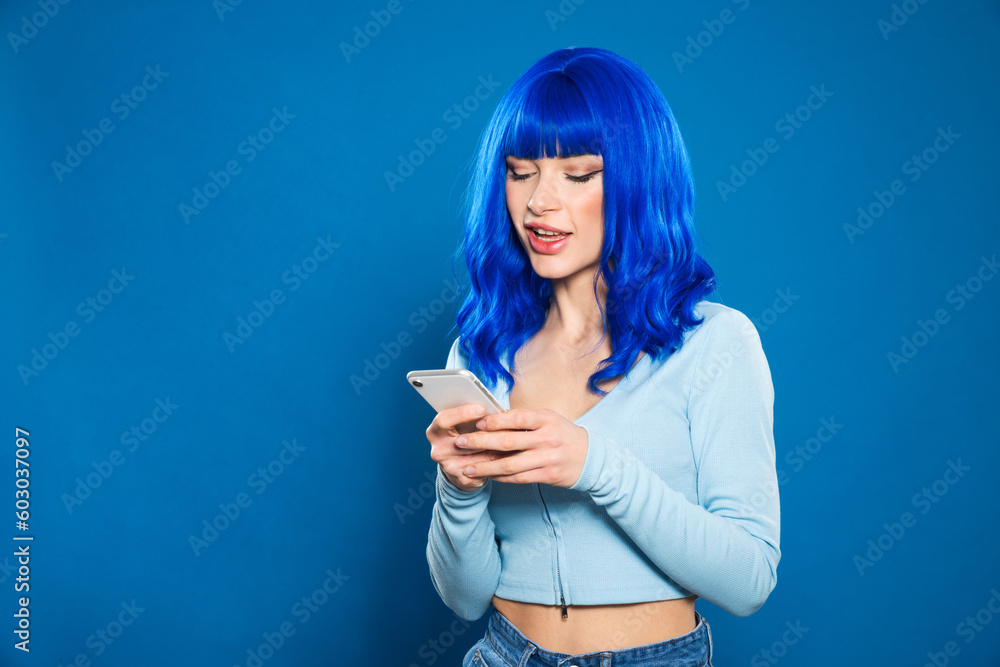 Futuristic woman using smartphone in studio Futuristic woman using smartphone in studio