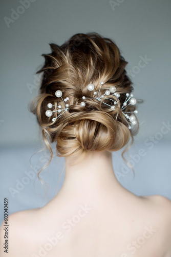 Wedding hairstyle for long blonde hair with pearl decoration