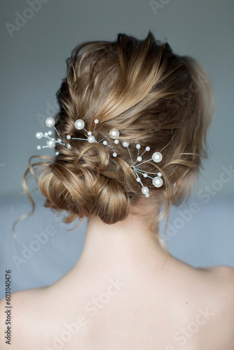 Wedding hairstyle for long blonde hair with pearl decoration