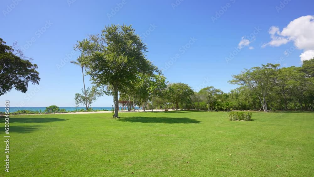 Green grass view and beautiful blue water of sea. coastal golf course