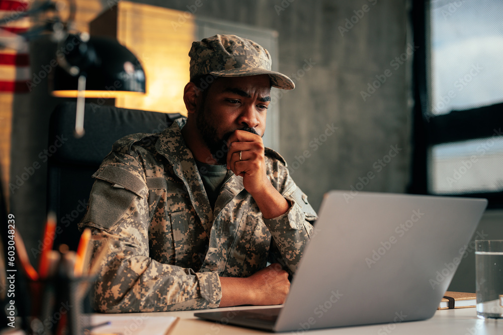 Serious soldier working in office.