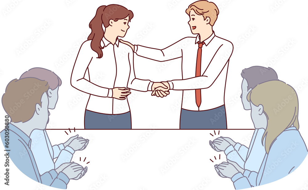 Handshake of boss and new employee of company during business meeting with colleagues Handshake of boss and new employee of company during business meeting with colleagues
