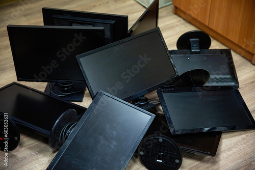 Black, old, dusty, computer monitors in a pile. Computer junk.