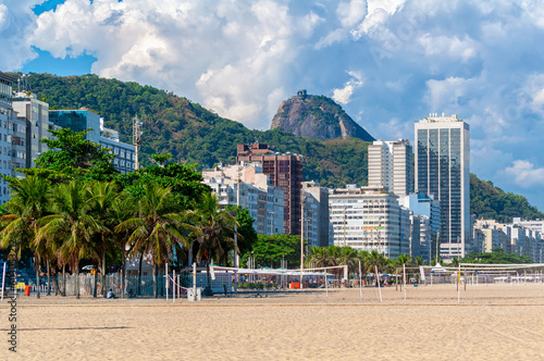 Copacabana beach and mountain Sugarloaf in Rio de Janeiro, Brazil. Copacabana beach is the most famous beach in Rio de Janeiro. Sunny cityscape of Rio de Janeiro