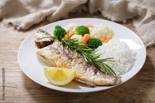 plate of fried fish, rice and vegetables