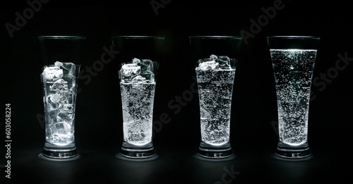 Four glasses filled up with ice and water