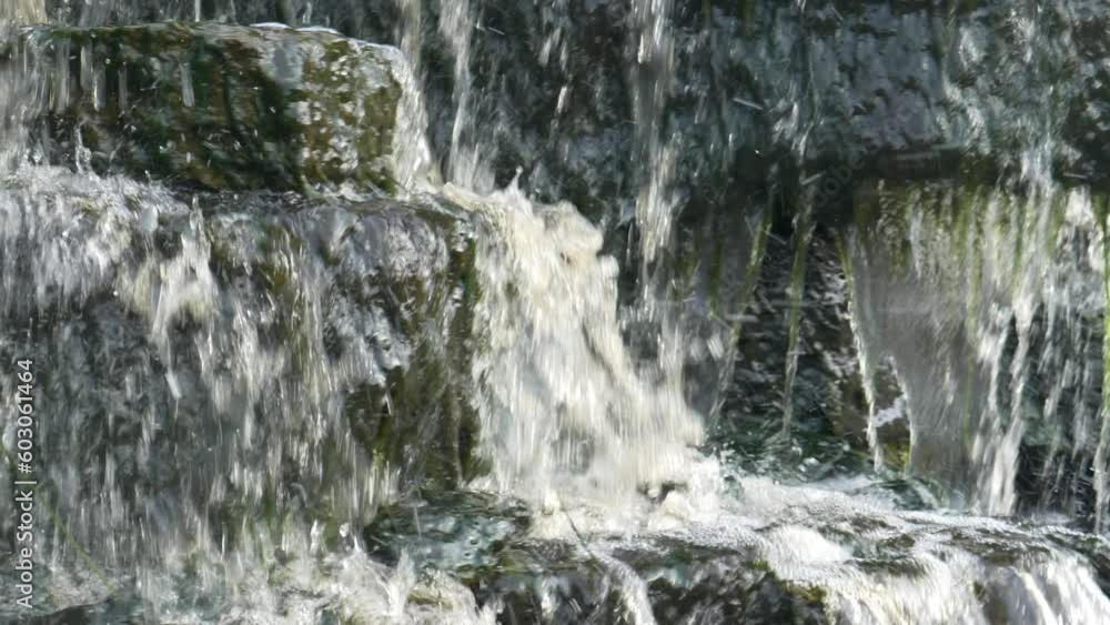 Waterfall, water flowing from the river falls down. A stormy river with a brown hue. Waterfall, water flowing from the river falls down. A stormy river with a brown hue.