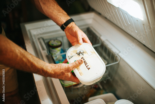 Putting away ice cream in the freezer photo