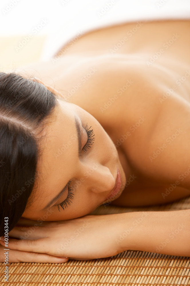 Portrait of Fresh and Beautiful brunette woman laying on bamboo mat Portrait of Fresh and Beautiful brunette woman laying on bamboo mat