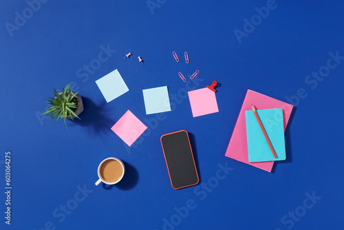 Working table with notebook, mobile phone and milk coffee