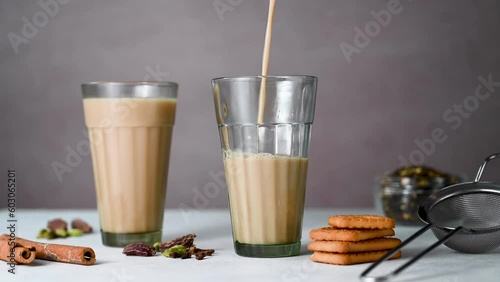 Pouring fresh indian masala chai tea. Two glasses with traditional chai tea. Real time vidoe photo