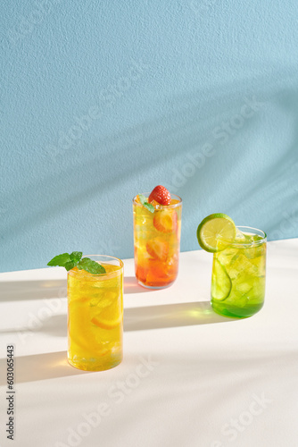 Summer refreshing fruit drinks with ice on a light background photo