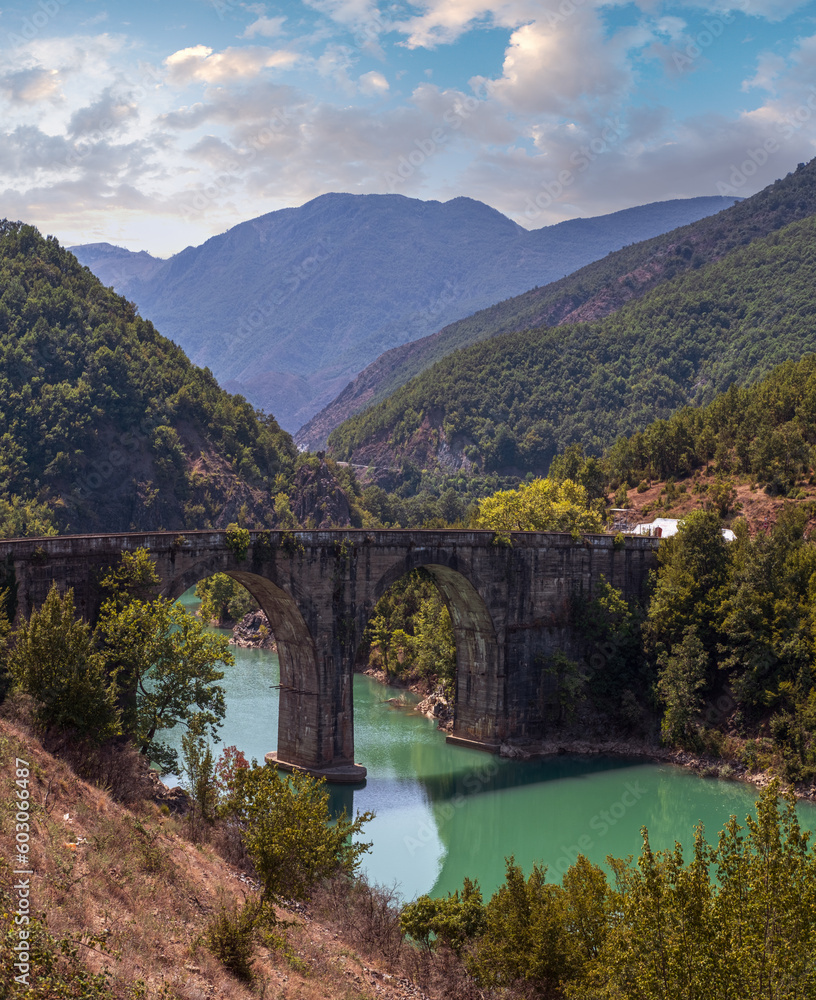 Ura e Ulzes bridge on one of most beautiful roads in Albania along the Shkopet Lake precipitous сoast. Lake Ulza Nature Park, Diber County, Balkan mountains, Albania, Europe.