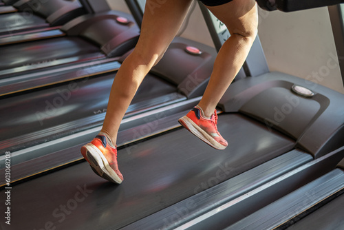 Unrecognizable People Running In Machine Treadmill At Fitness Gym Club