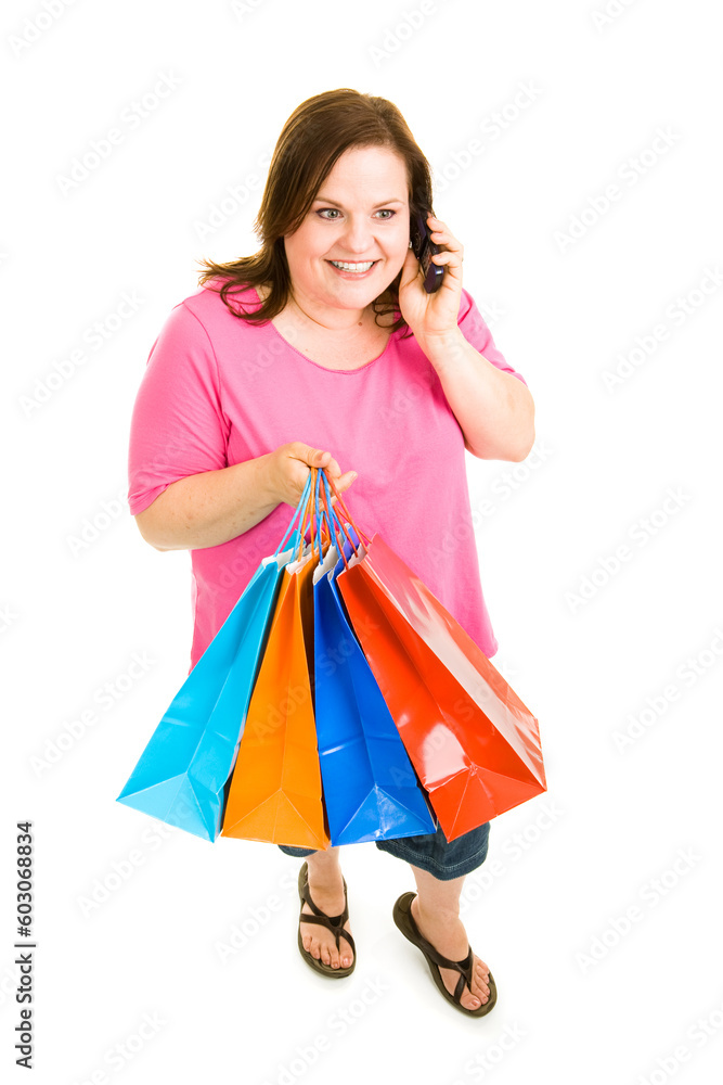 Pretty plus-sized woman holding her shopping bags and talking on the phone. Full body isolated on white. Pretty plus-sized woman holding her shopping bags and talking on the phone. Full body isolated on white.