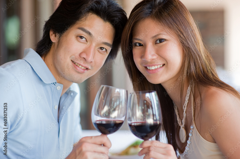 A young couple with red wine at a restaurant A young couple with red wine at a restaurant
