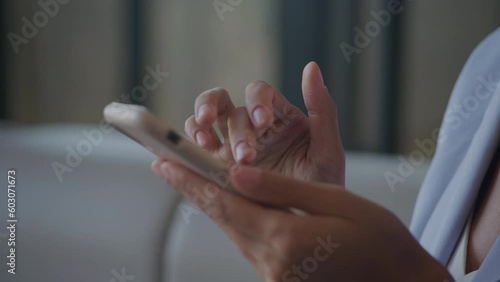 Businesswoman hands browsing on smartphone extreme close up photo