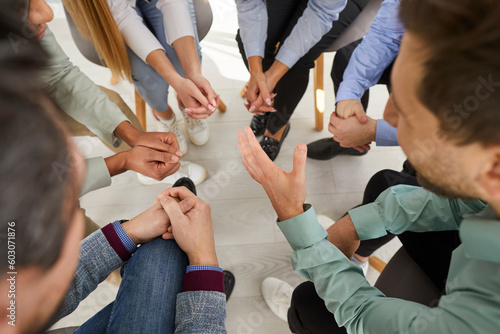 Business team having an interesting discussion during a meeting at work. Group of people sitting in a circle, talking about their common goal, sharing opinions and making suggestions. Teamwork concept