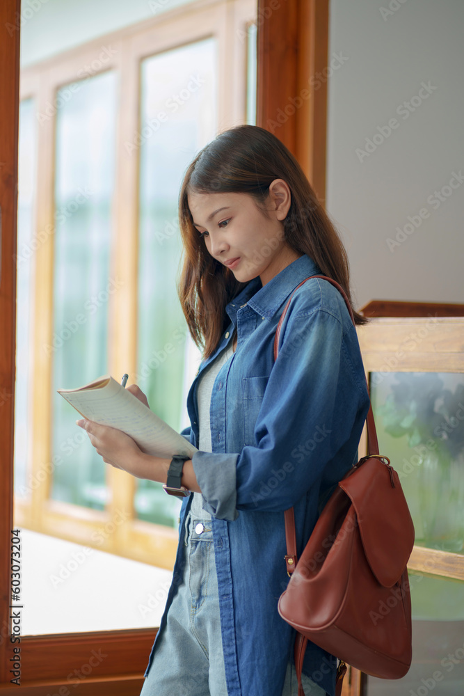 Portrait of Female Asian university taking notes.. Portrait of Female Asian university taking notes..