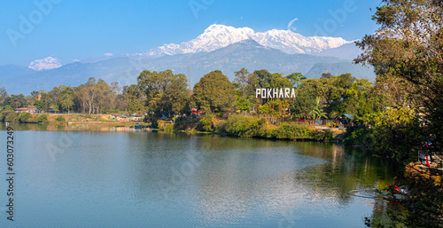 Pokhara sign, at lake in Nepal with himalaya in background