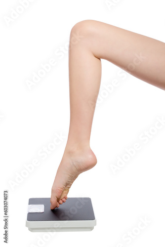 beautiful womans leg standing with the toe on a scale
