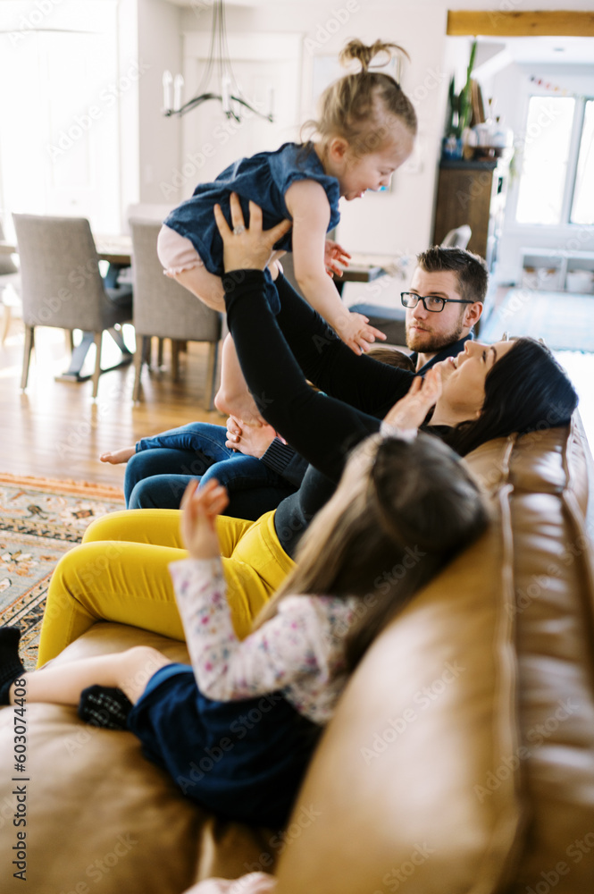 smiling happy family playing in their home together smiling happy family playing in their home together