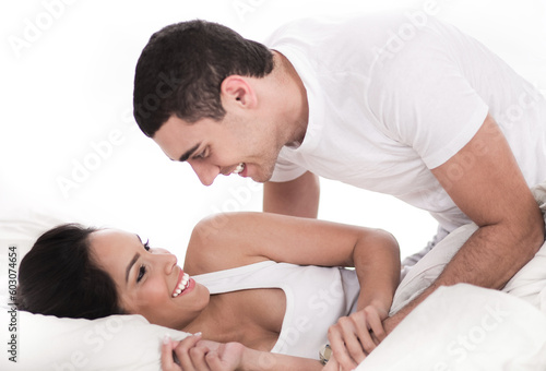 Loving affectionate couple in bed over white background