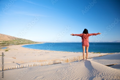 woman at sand dune in spain with african horizon