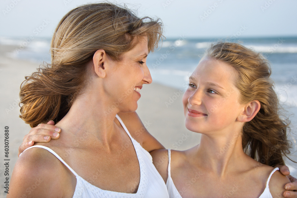 Mother and daughter smile with arms around one another. Horizontal shot. Mother and daughter smile with arms around one another. Horizontal shot.