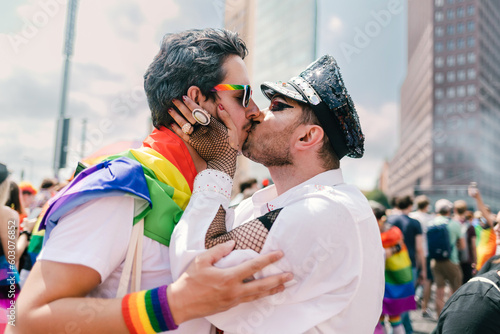 Gay couple sharing a kiss at Pride photo