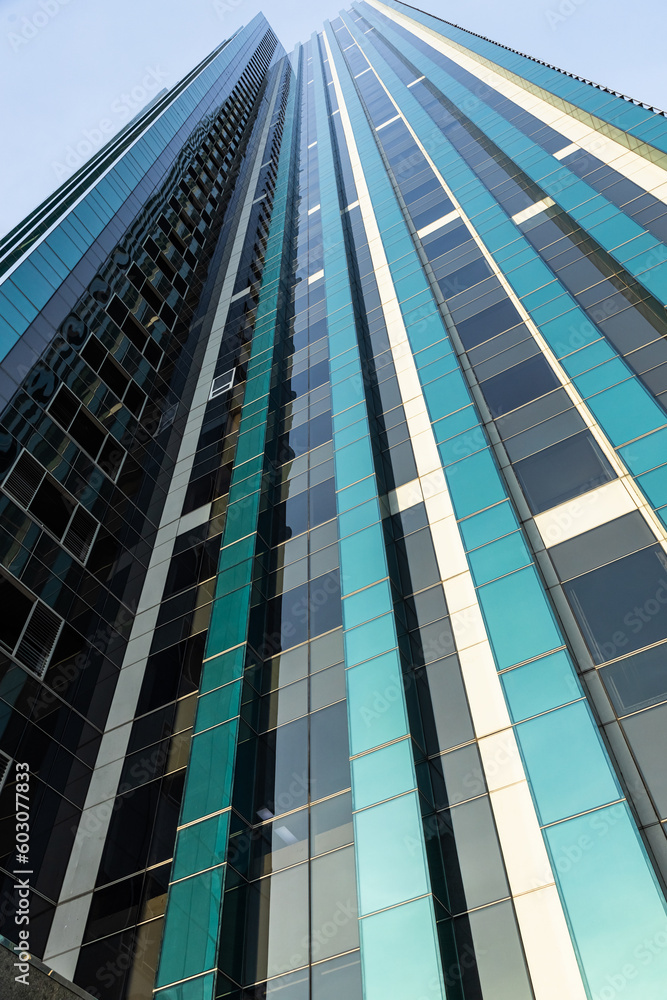 Glass office building against the sky closeup Glass office building against the sky closeup
