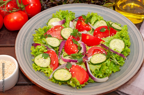 Salad of fresh tomatoes and cucumbers in a bowl
