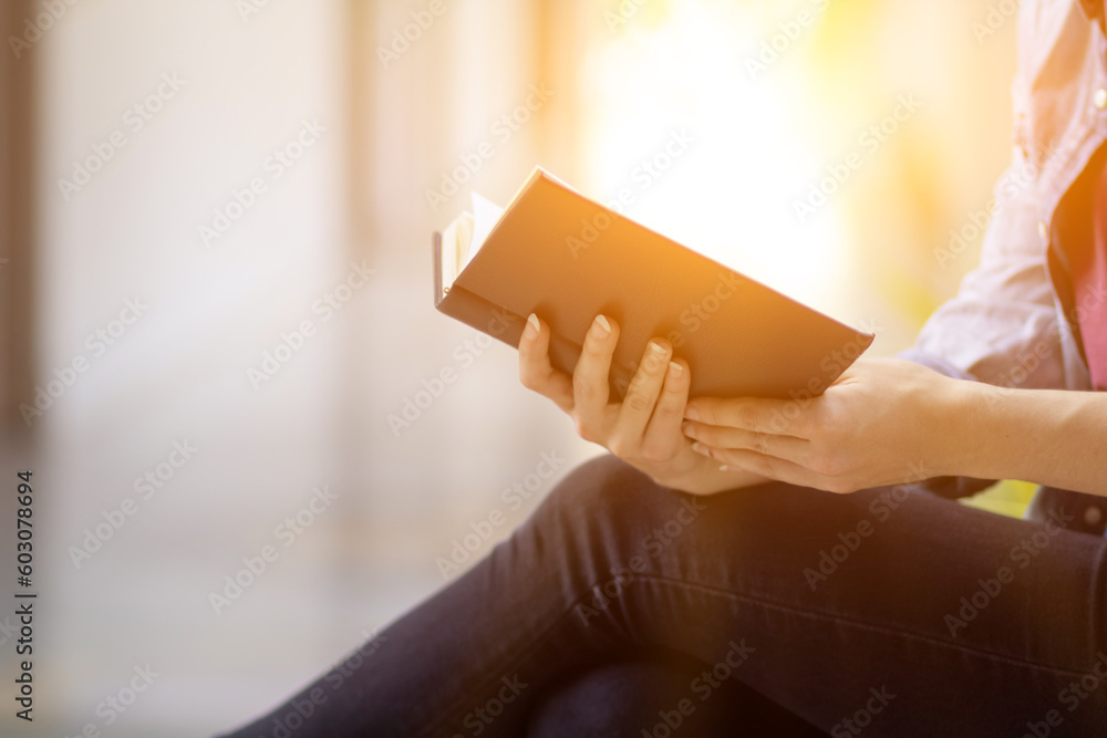 young girl holding Bible in her hand and reading it to understand its contents Bible With faith and power believe in teachings of God from Bible. concept of learning and understanding teachings of God - obrazy, fototapety, plakaty 