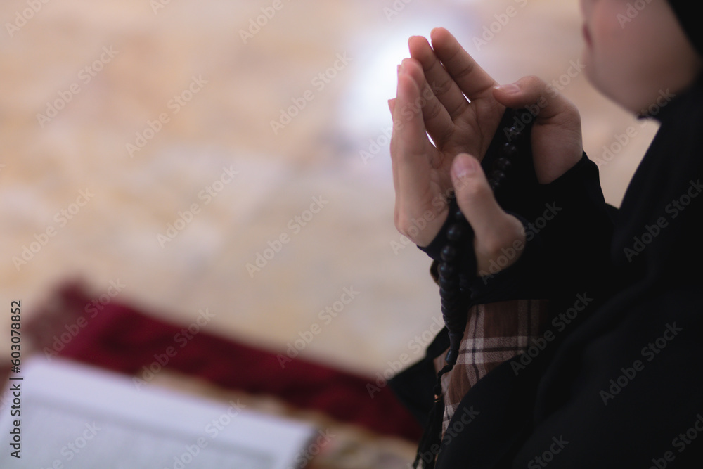 muslim women in hijab are praying to show respect and thanks to allah according to muslim belief and muslim women in hijab are praying to allah according to traditional belief from quran